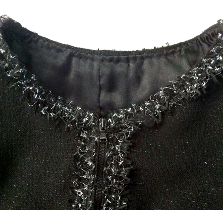 Chanel-style boxy jacket made from Mood Fabrics' Italian black wool boucle and Mood's fancy metallic fringe.