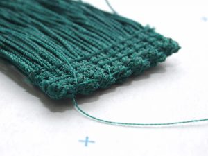 Sewn chainette fringe