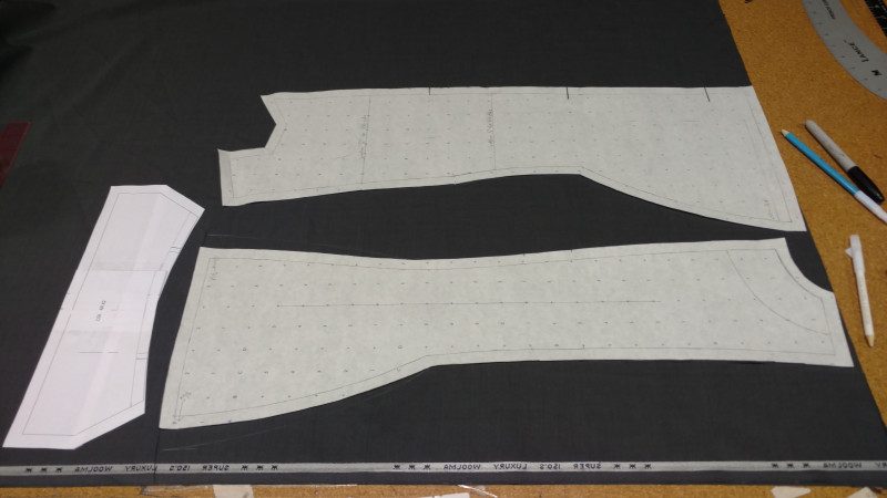 Cut the front and back out of two layers of suiting. The collar is shown for layout purposes, but you only need to cut one. The chalk lines are alterations to the pattern after doing the mockup.