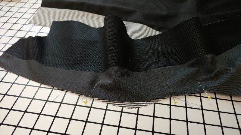 For a curved seam to work, the seam allowance on one side will be longer than the seam itself, and the other side's seam allowance will often be shorter.