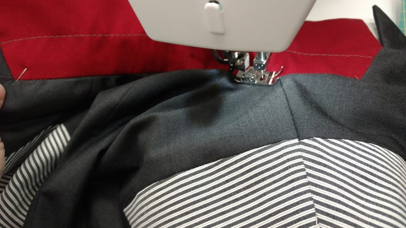 Stitching in the ditch will keep the neck edge seams on the lining and fashion layer aligned.